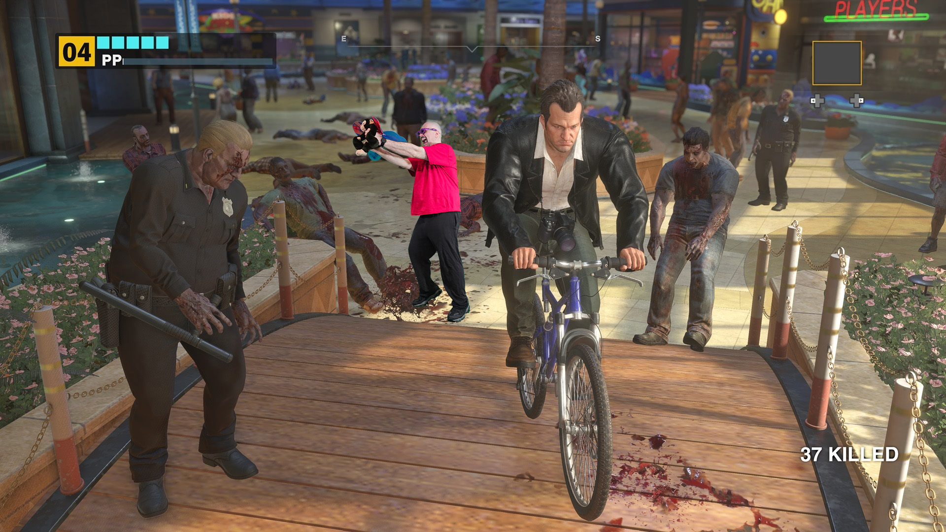 Frank West in Dead Rising, riding a bicycle through a zombie-infested mall. A man in pink throws a zombie head. The Dead Rising Deluxe Remaster features enhanced graphics and gameplay.